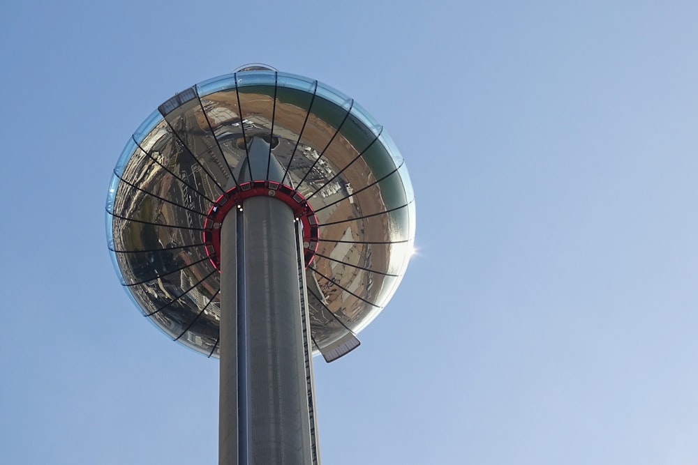 a very tall metal pole with a very large dome on top of it