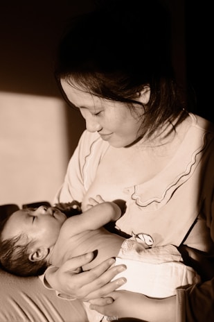 a woman holding a baby in her arms