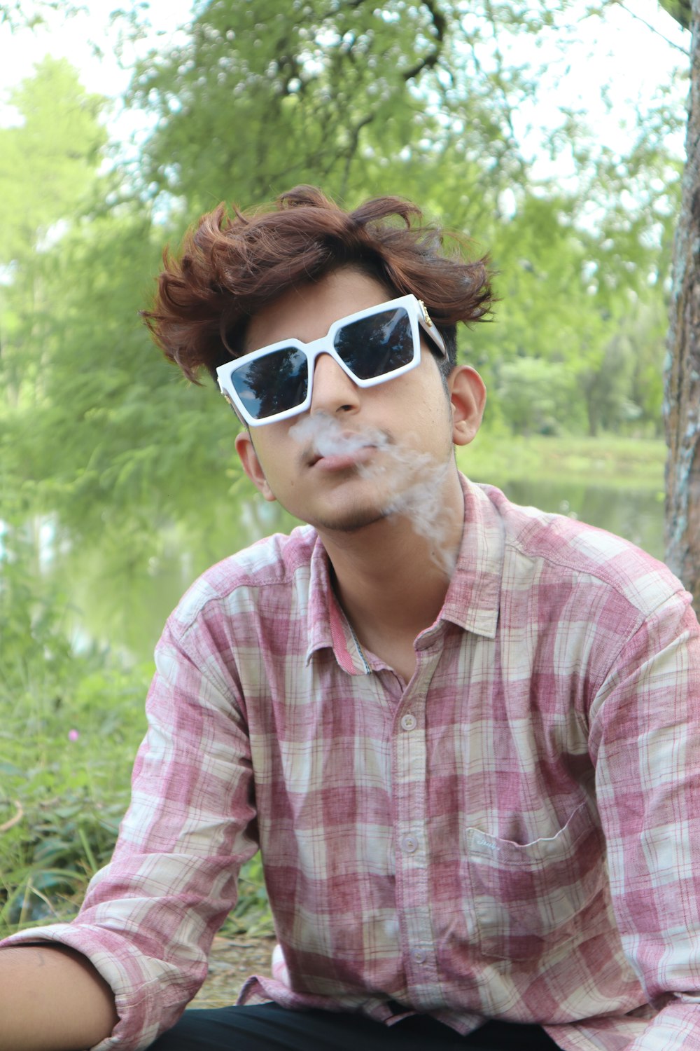 a man with sunglasses and a cigarette in his mouth