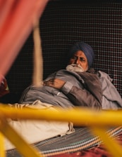a man with a turban is laying in a bed