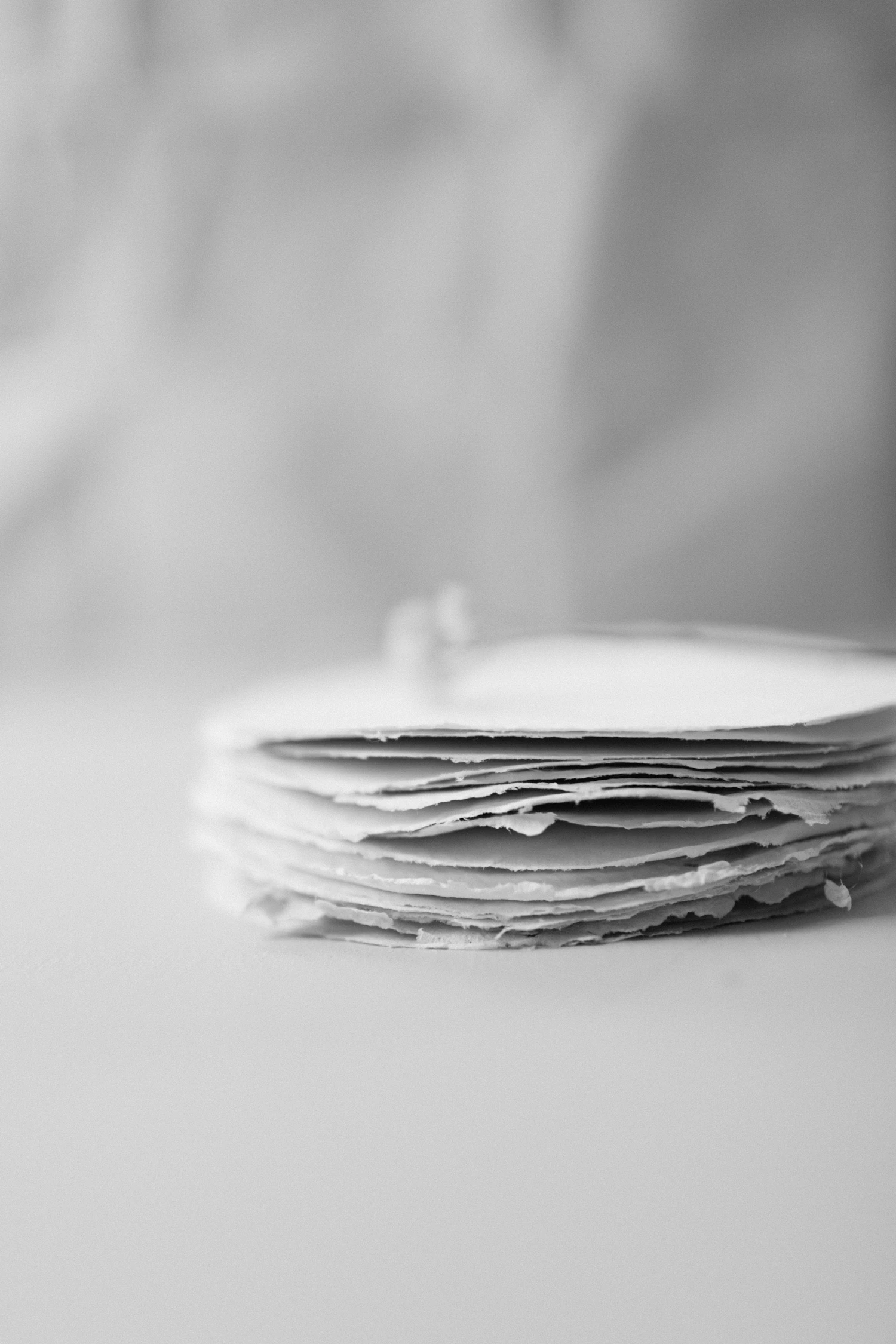 A stack of hand-cut 120 gsm sheets on the cutting table