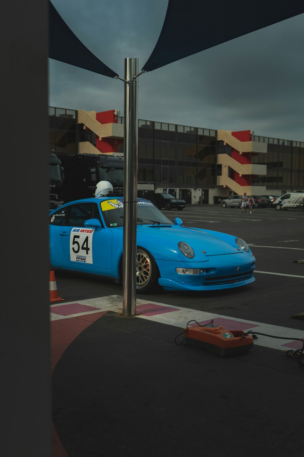 a blue car is parked in a parking lot