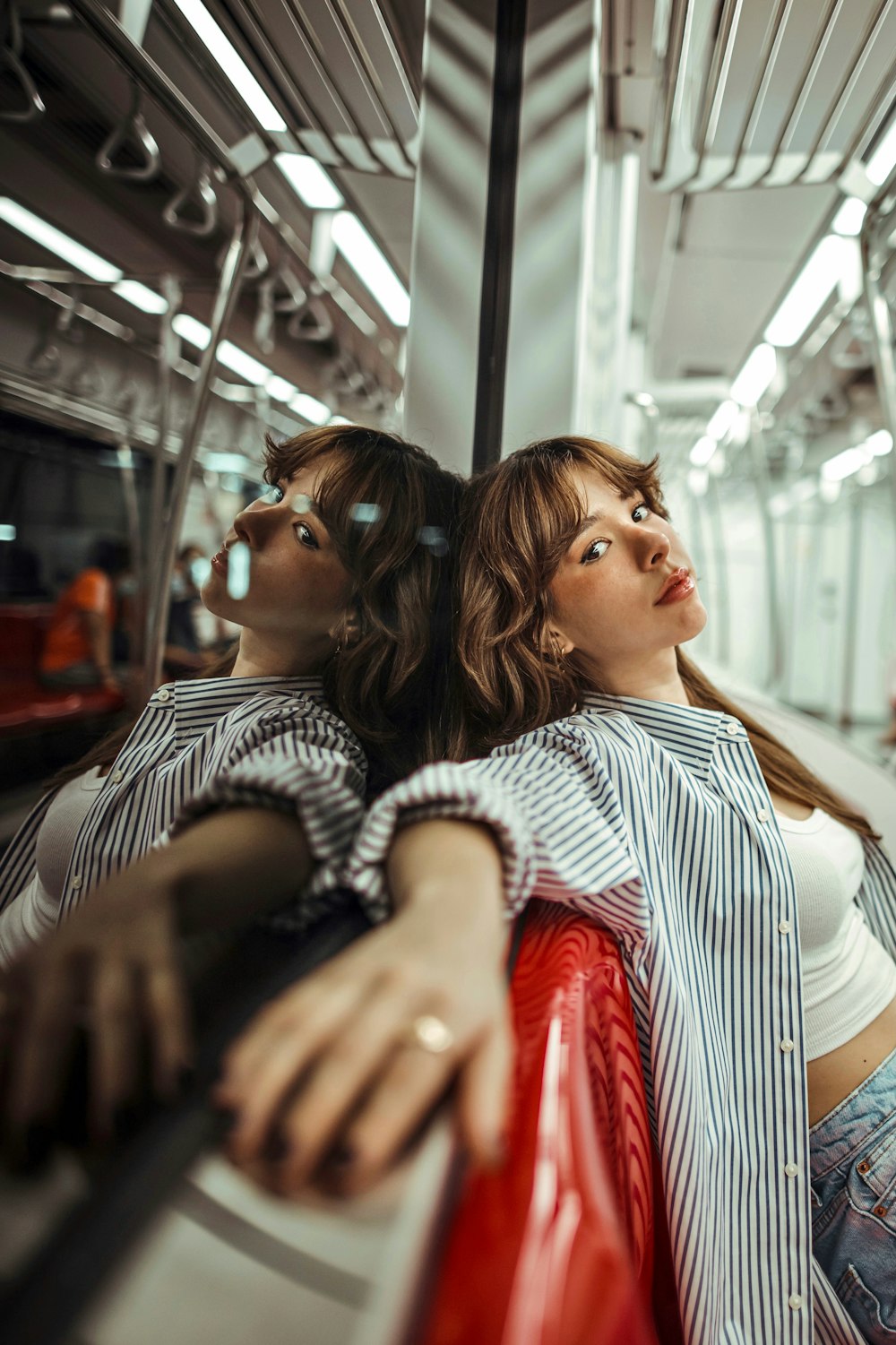 a couple of women sitting next to each other on a train