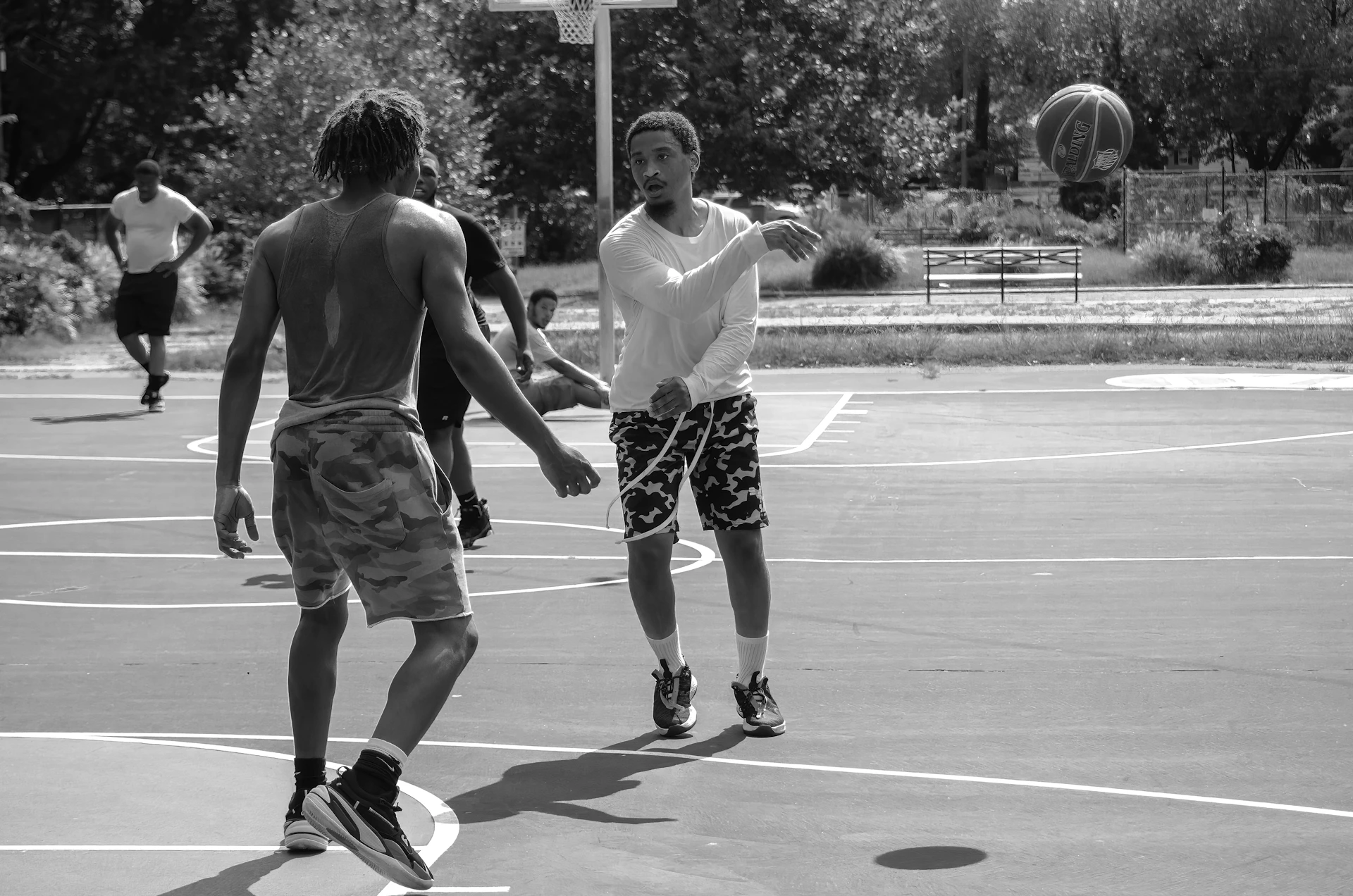 a group of young men playing a game of basketball