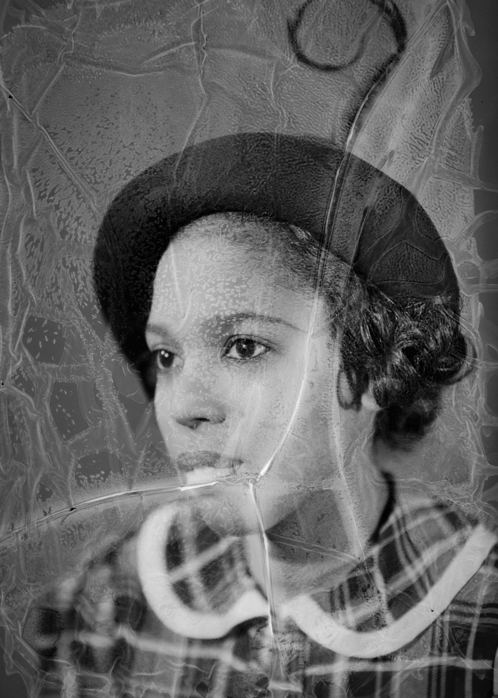 a black and white photo of a woman wearing a hat