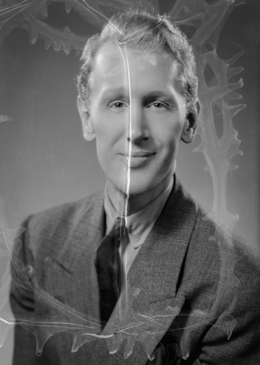 a black and white photo of a man in a suit and tie