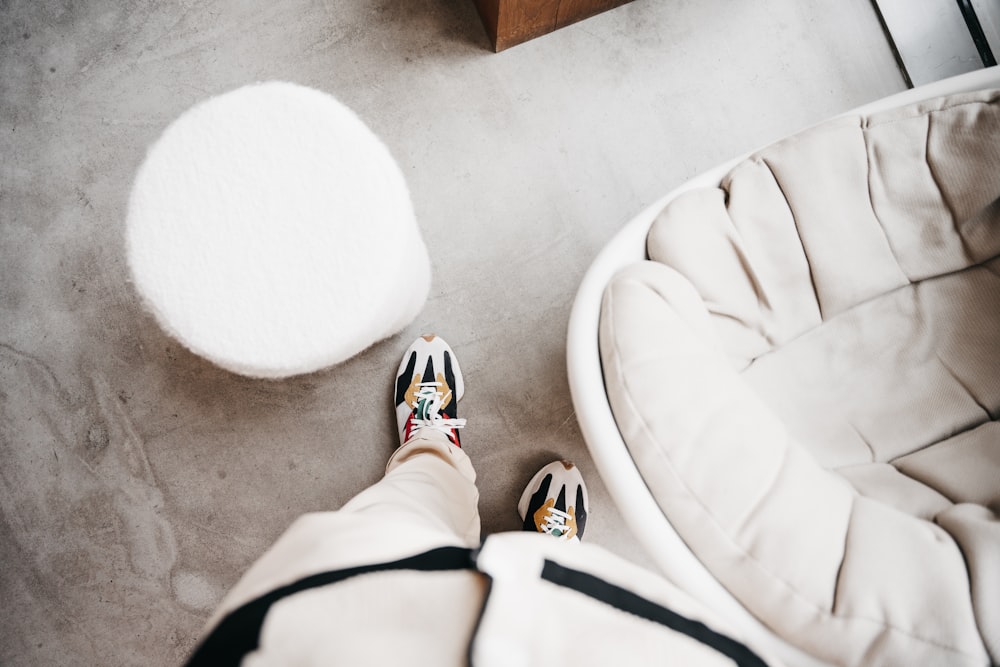 a person standing next to a white chair