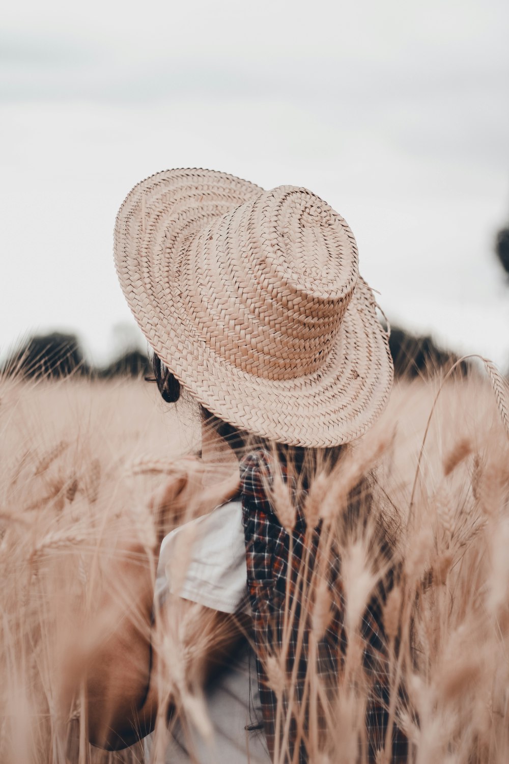 a person standing in a field with a hat on