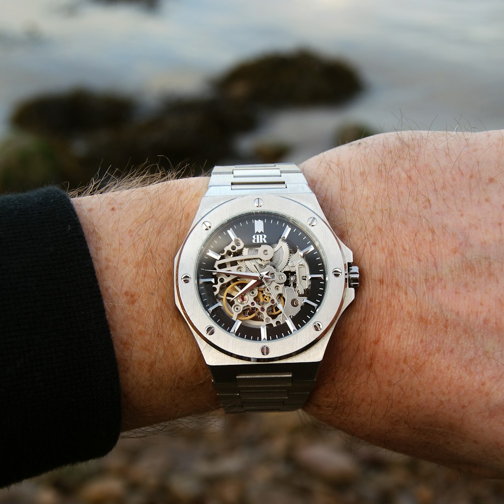 a man's wrist with a watch on it
