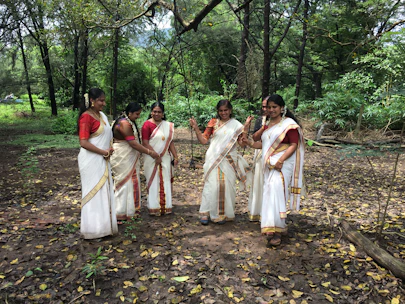 A group of women collaborating on a rural development project in an Indian village.