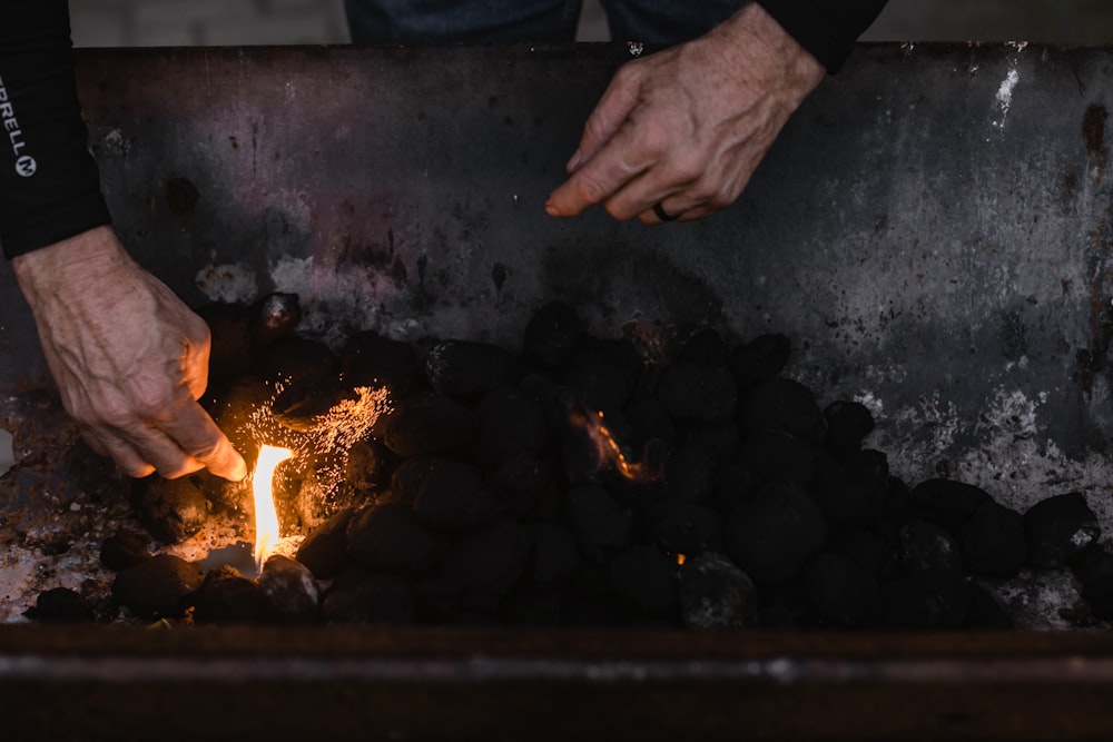 a person lighting a fire with their hands