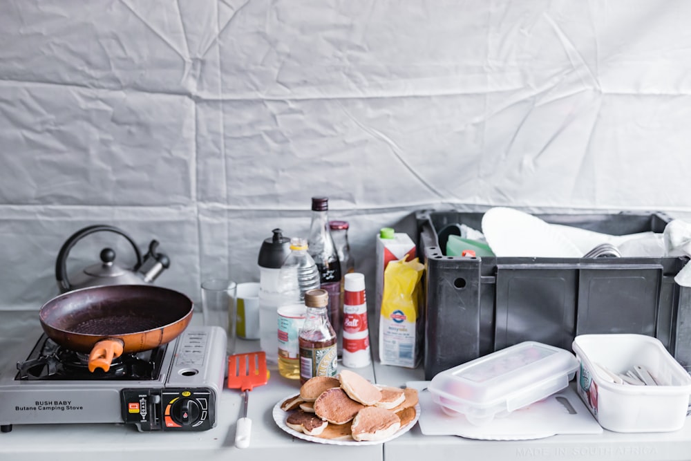 a stove top with a plate of food on it