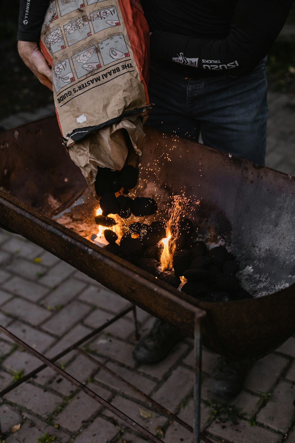 eine Person, die eine Tasche über einer Feuerstelle hält