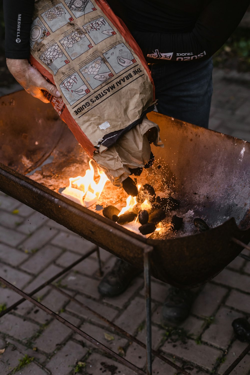 a person holding a bag of food over a fire