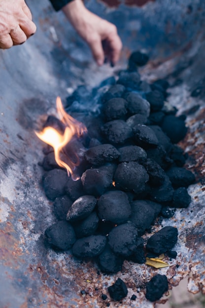 a close up of a person cooking food on a grill