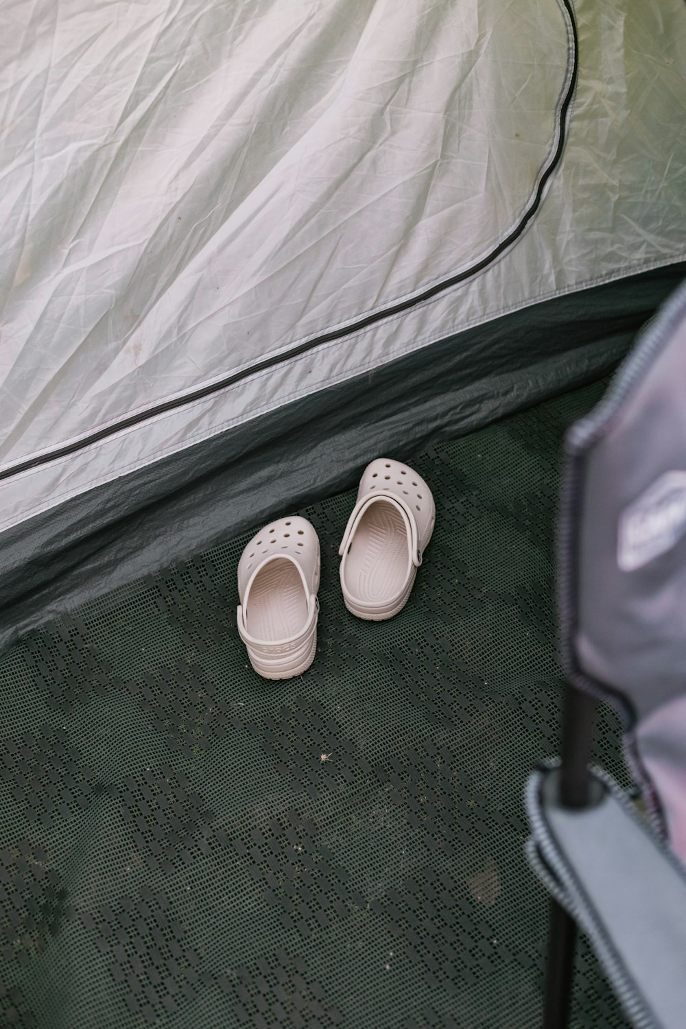 a pair of shoes sitting in front of a tent