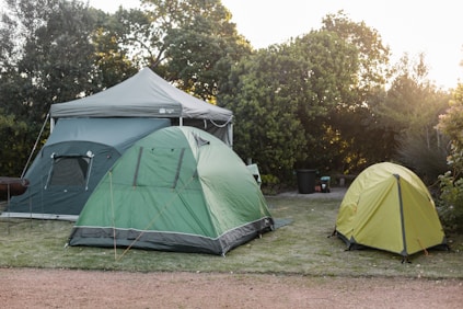 a couple of tents sitting on top of a lush green field