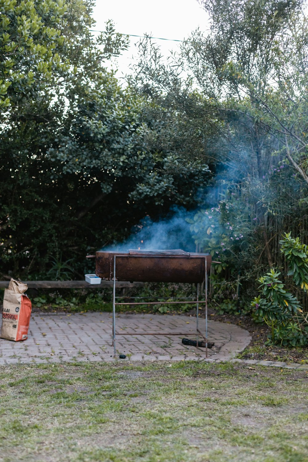 a bbq grill with smoke coming out of it