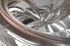 An intricate sculpture of intertwined metal shapes creating fluid motion.