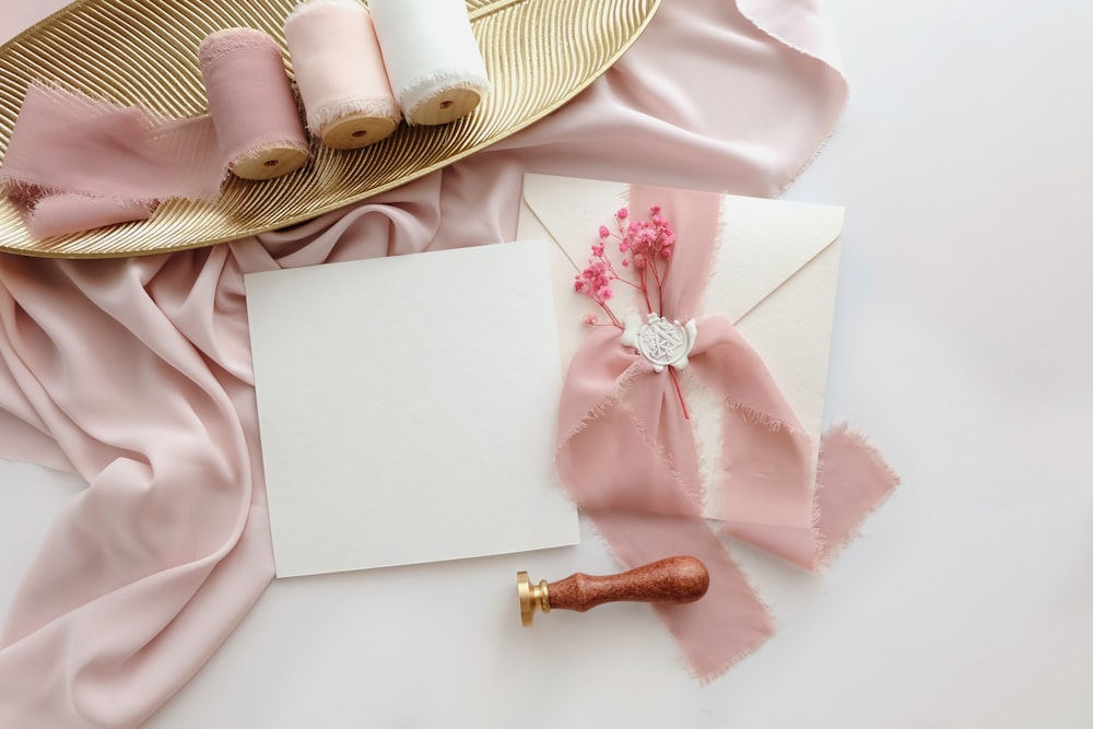 a table topped with pink and white items