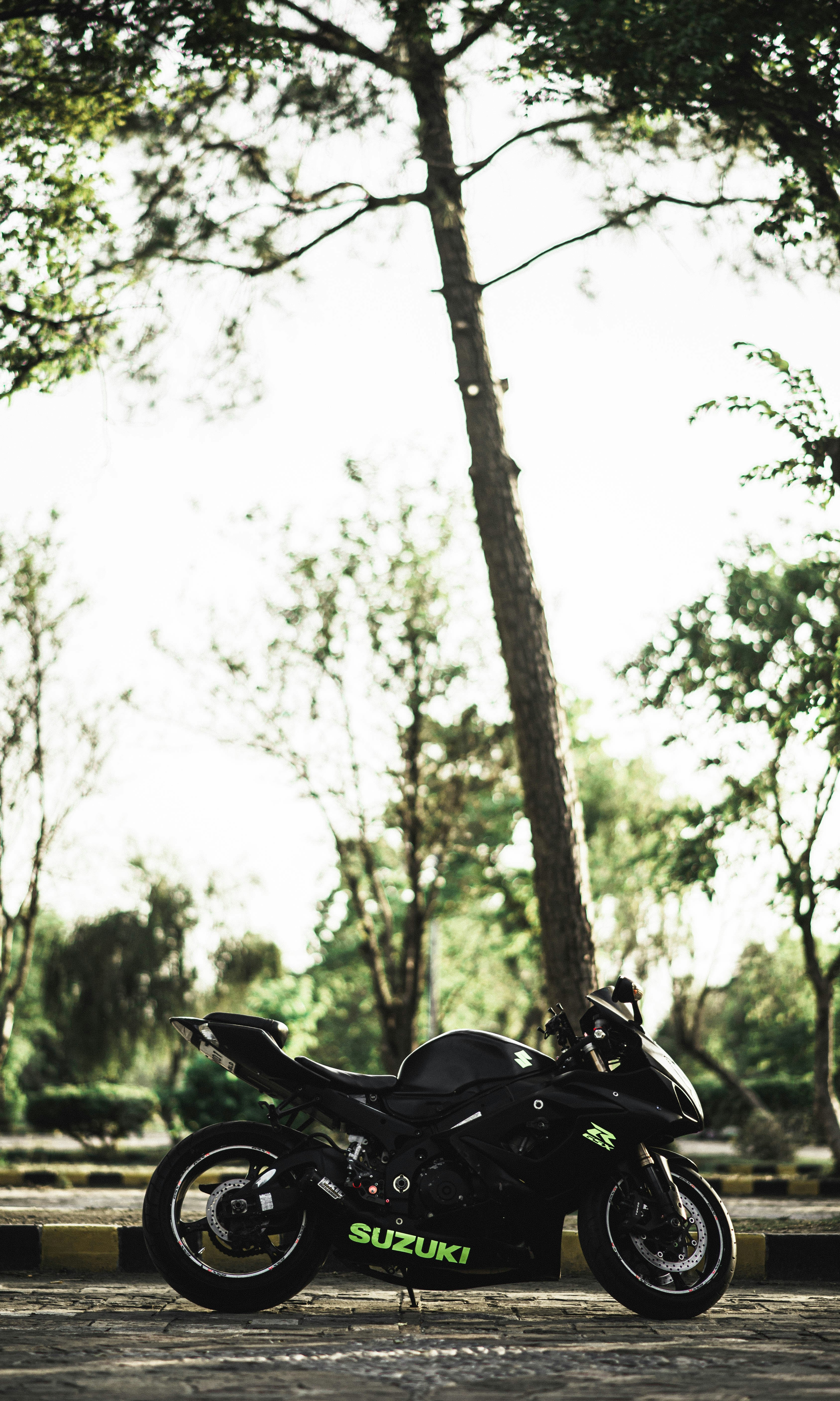 A motorcycle parked on the side of the road photo – Free ...