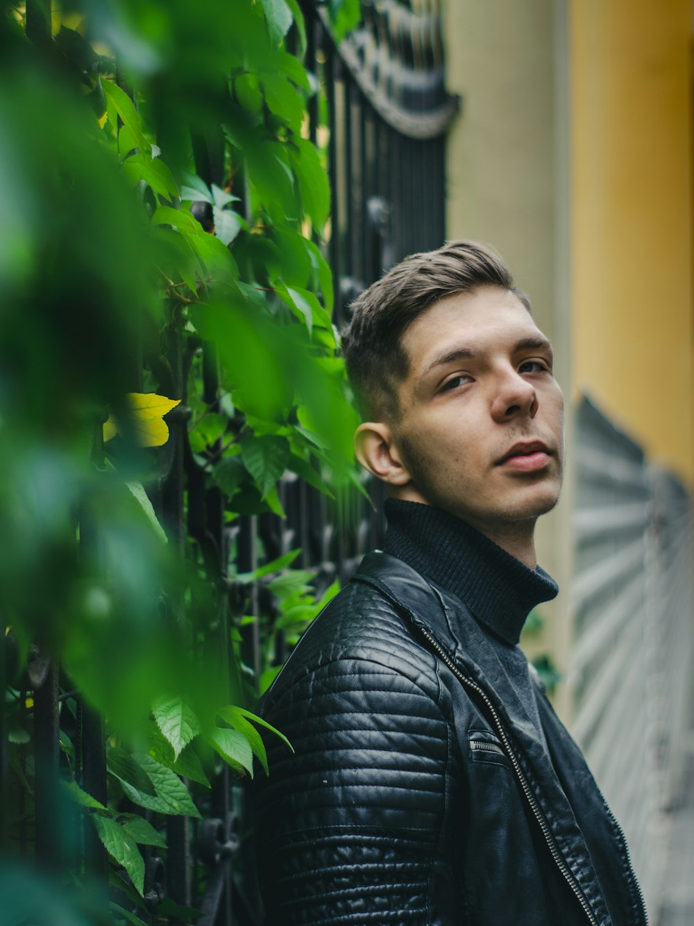 a man standing in front of a fence