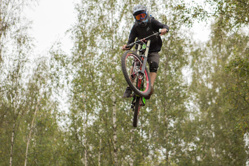 a man riding a bike up in the air