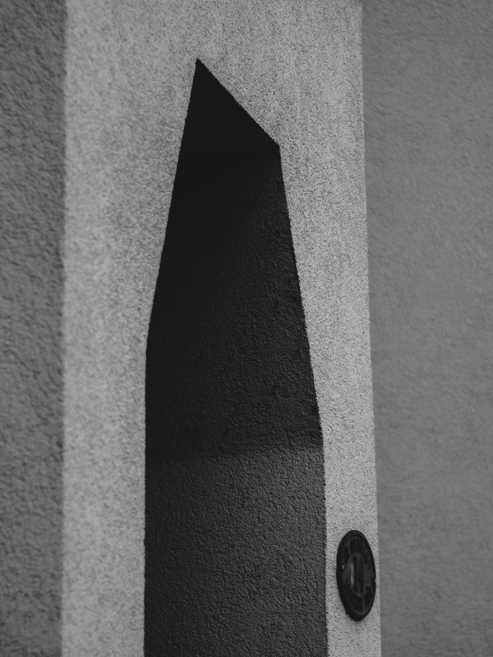 a black and white photo of a door and a wall