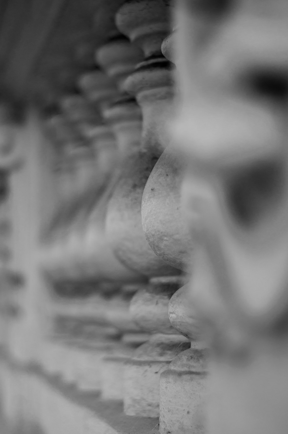 a black and white photo of a row of vases