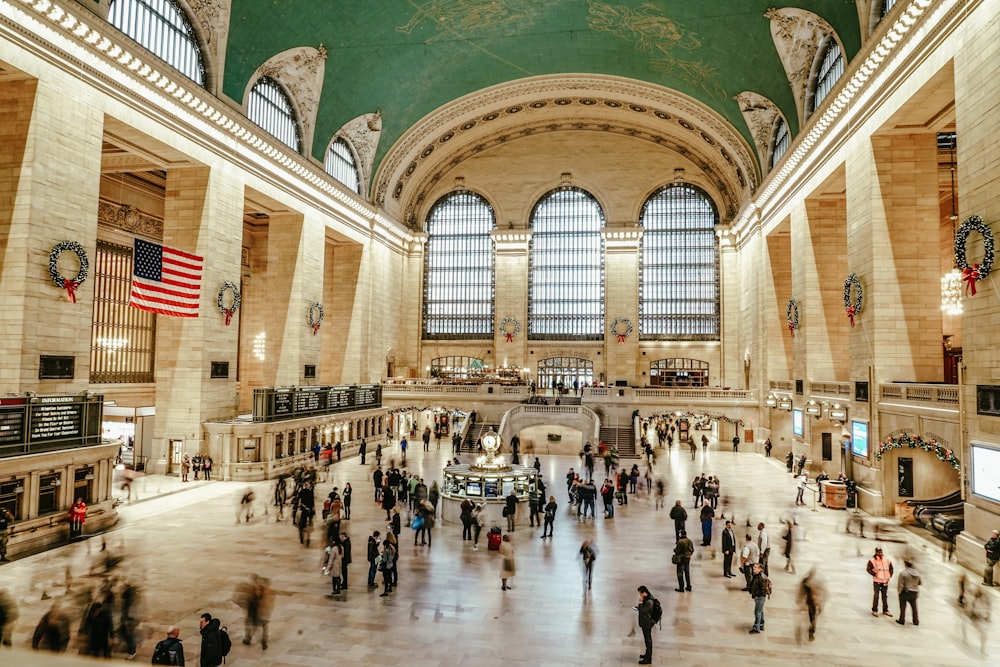 a group of people standing inside of a train station