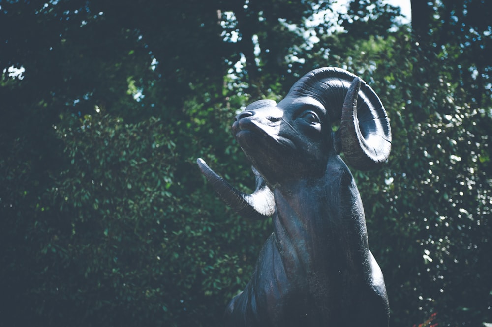 a statue of a goat with a bell around its neck