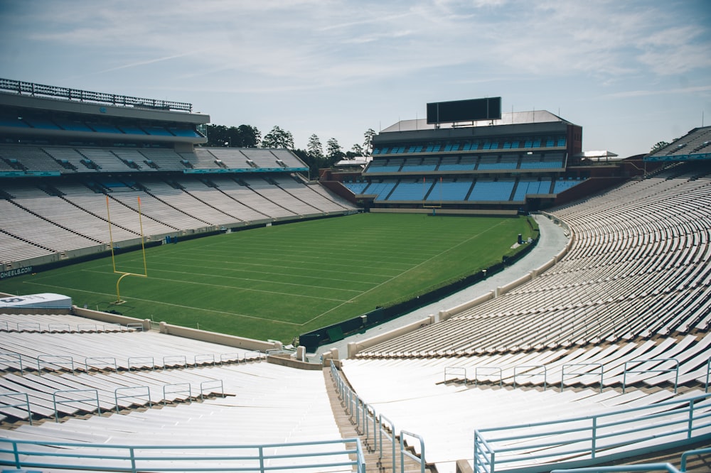 a large empty stadium with a green field