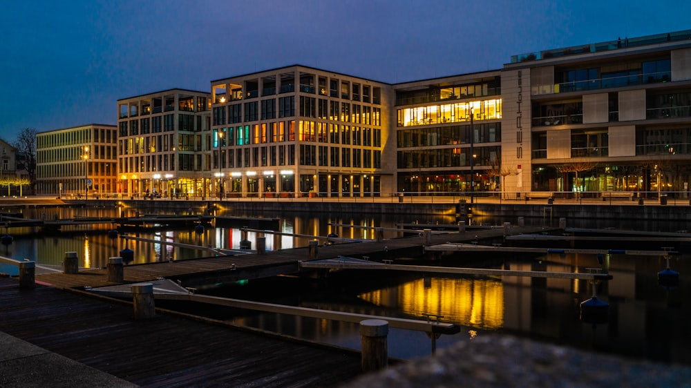 a building with a lot of windows next to a body of water