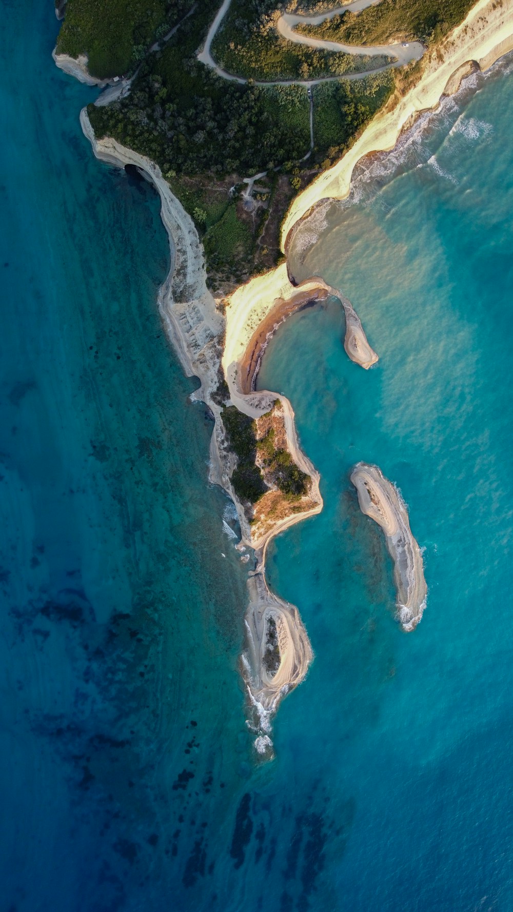 an aerial view of a sandy beach and ocean