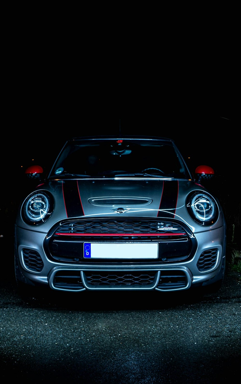 a car parked in the dark with its lights on