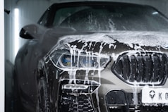 a car is covered in snow in a garage