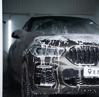 a car is covered in snow in a garage