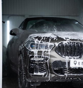 a car is covered in snow in a garage