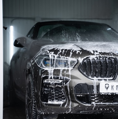 a car is covered in snow in a garage