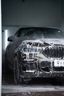 a car is covered in snow in a garage