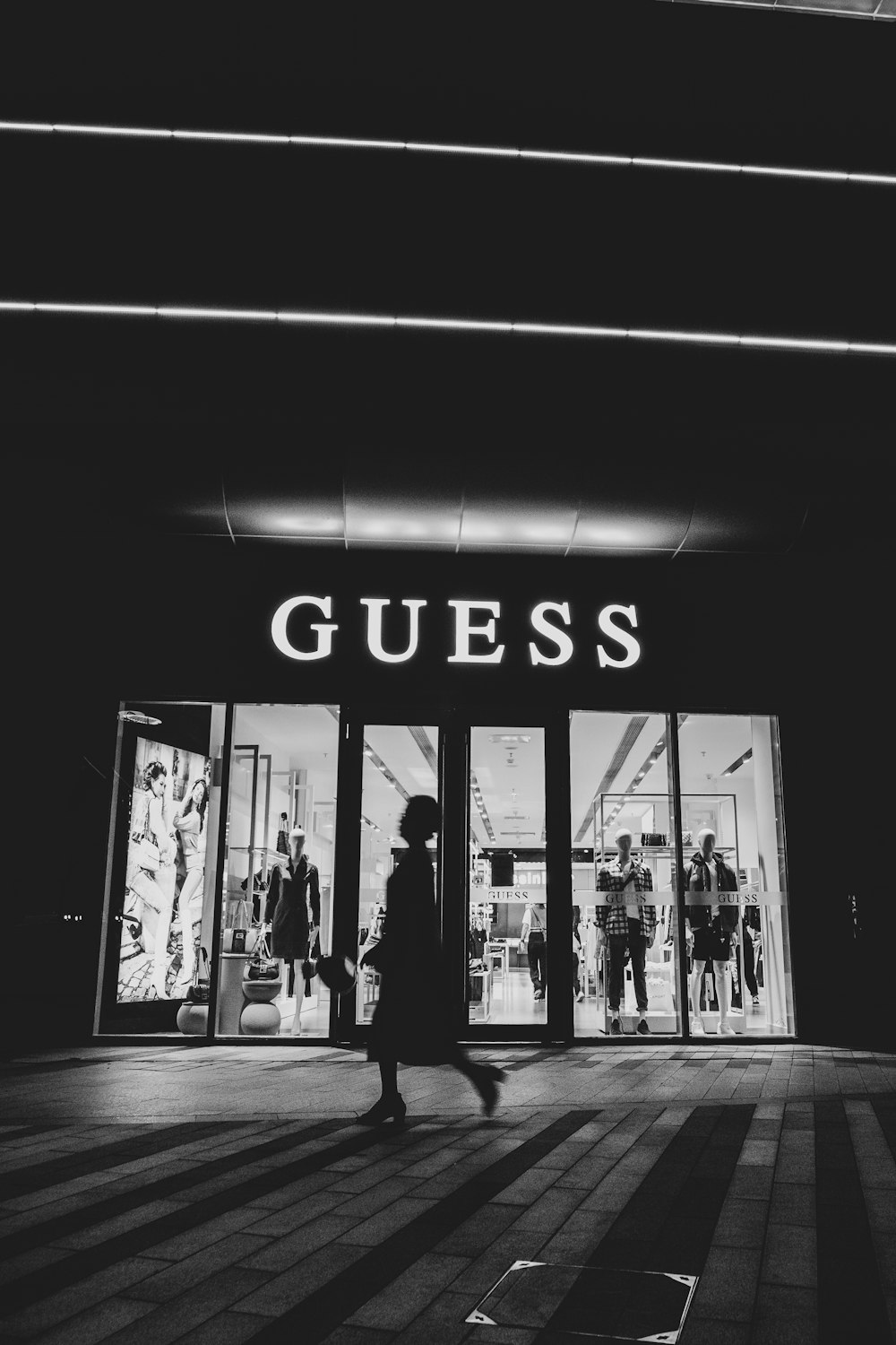 a black and white photo of a guess store