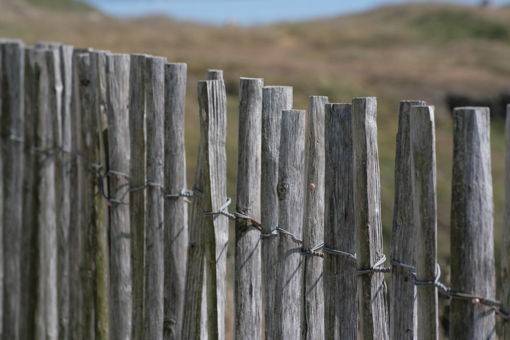 a close up of a wooden fence with barbed wire