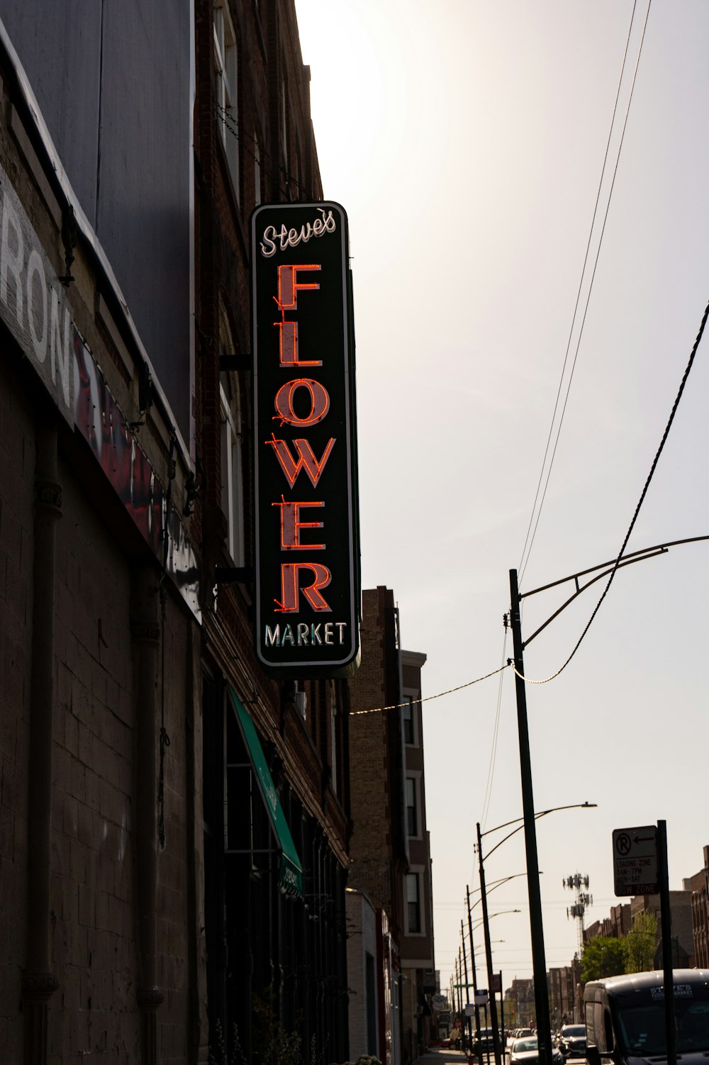 a flower market sign on the side of a building