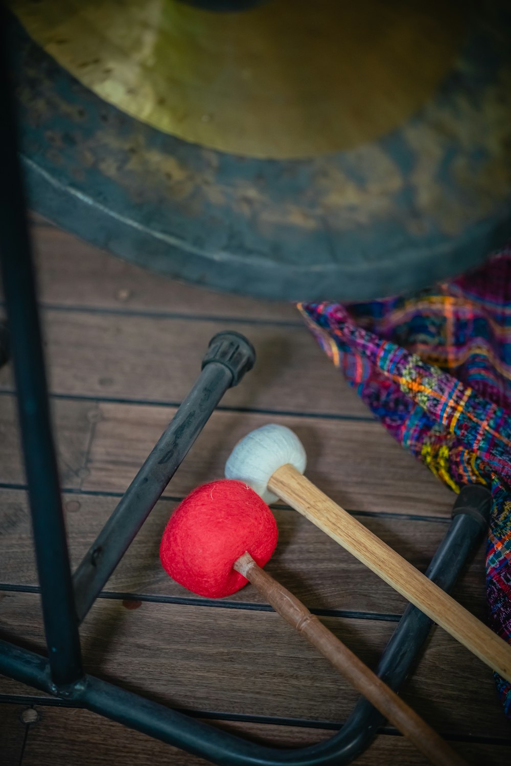 a pair of mallets and a red ball on a wooden floor