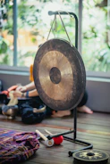 a person sitting on the floor next to a gong