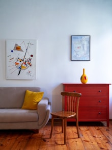 a living room with a couch a chair and a painting