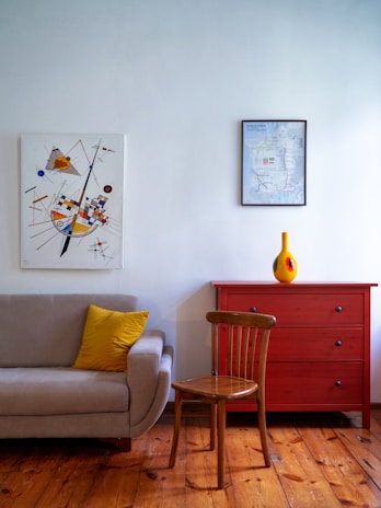 A cozy living room corner featuring a lemon-yellow accent wall with a stylish switch plate.