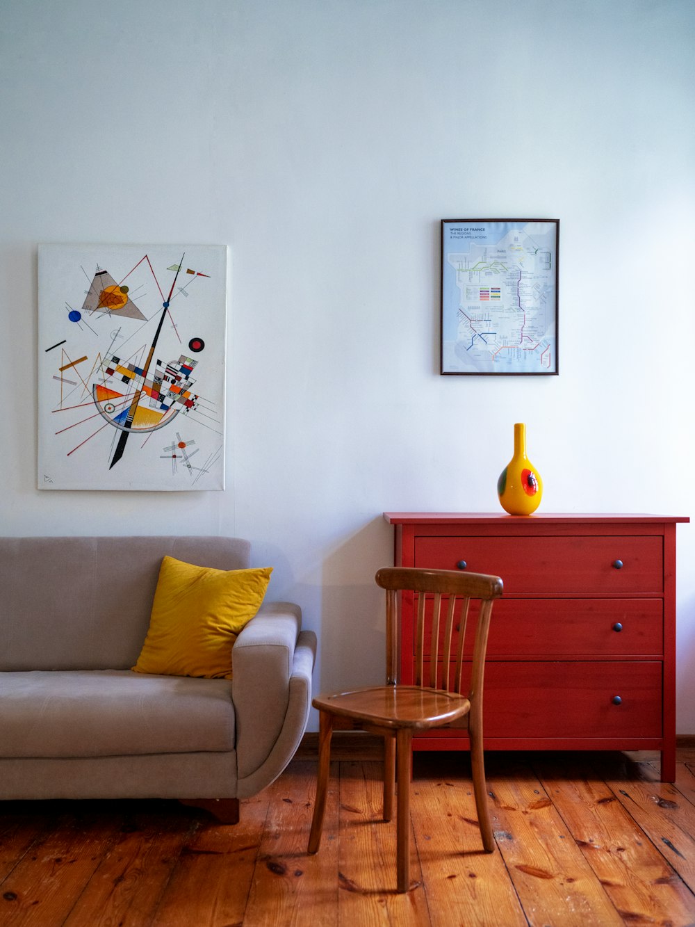 a living room with a couch a chair and a painting