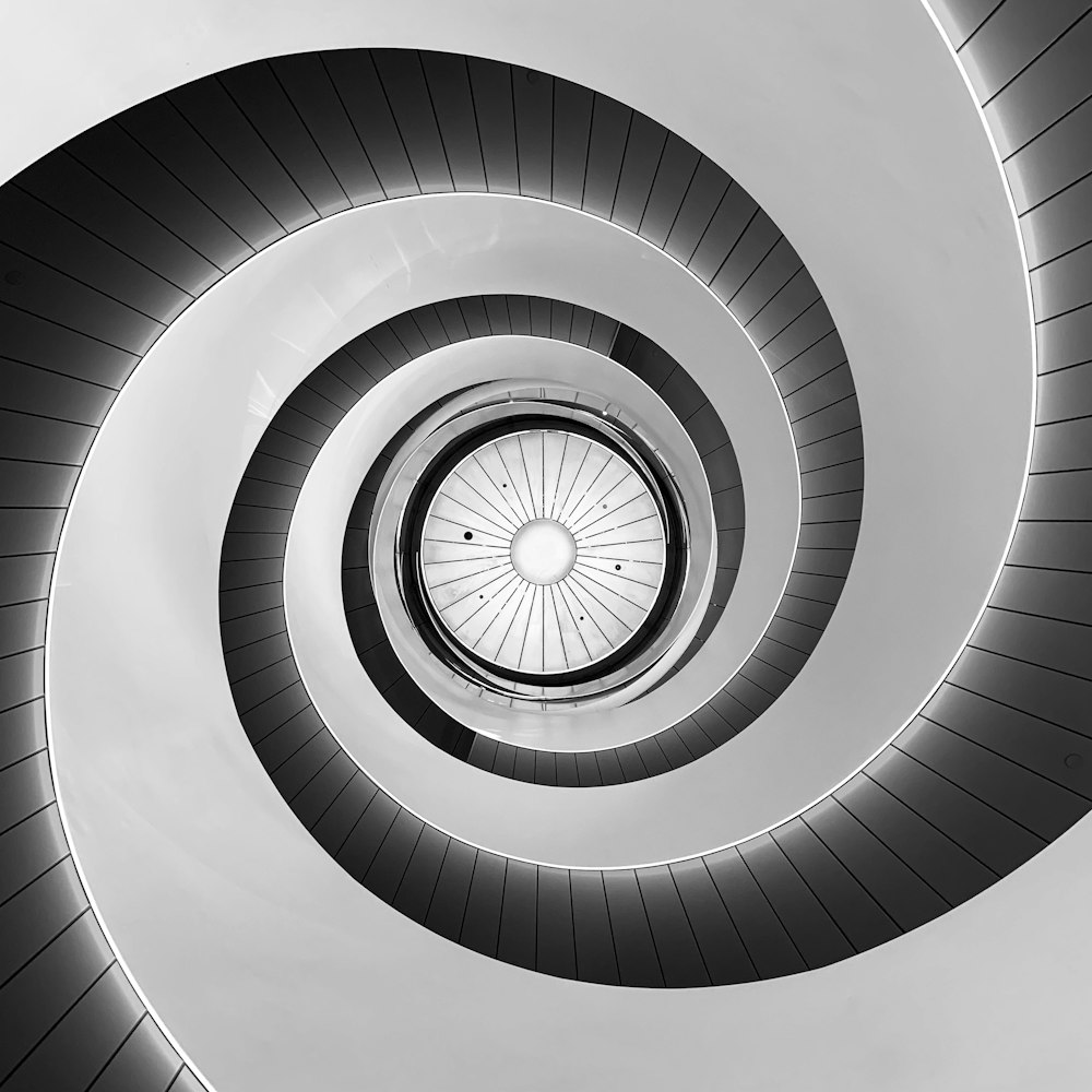 a black and white photo of a spiral staircase