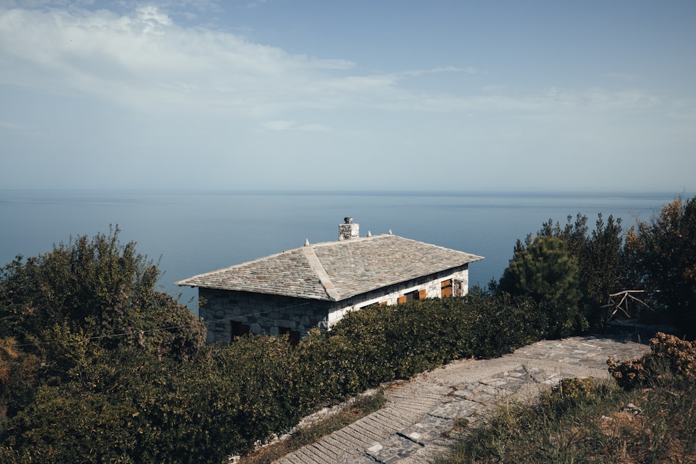 a house on a hill overlooking the ocean